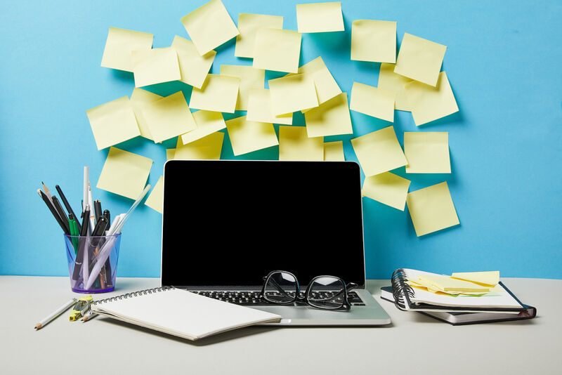A laptop covered in post-it notes